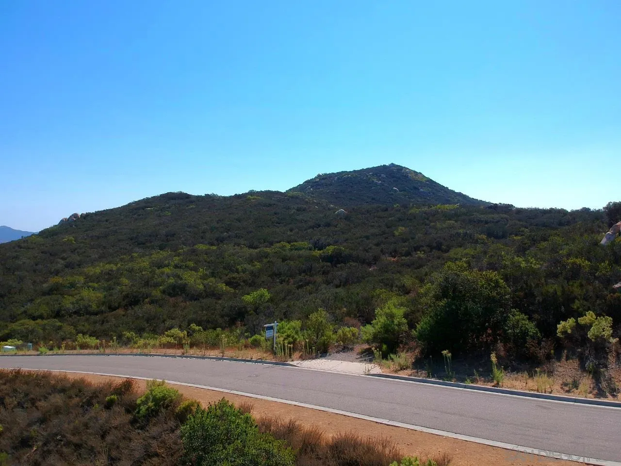 7 Del Poniente Road, Unit 7 Poway, CA 92064 - Photo 22 of 26 a view of a dry yard with a mountain