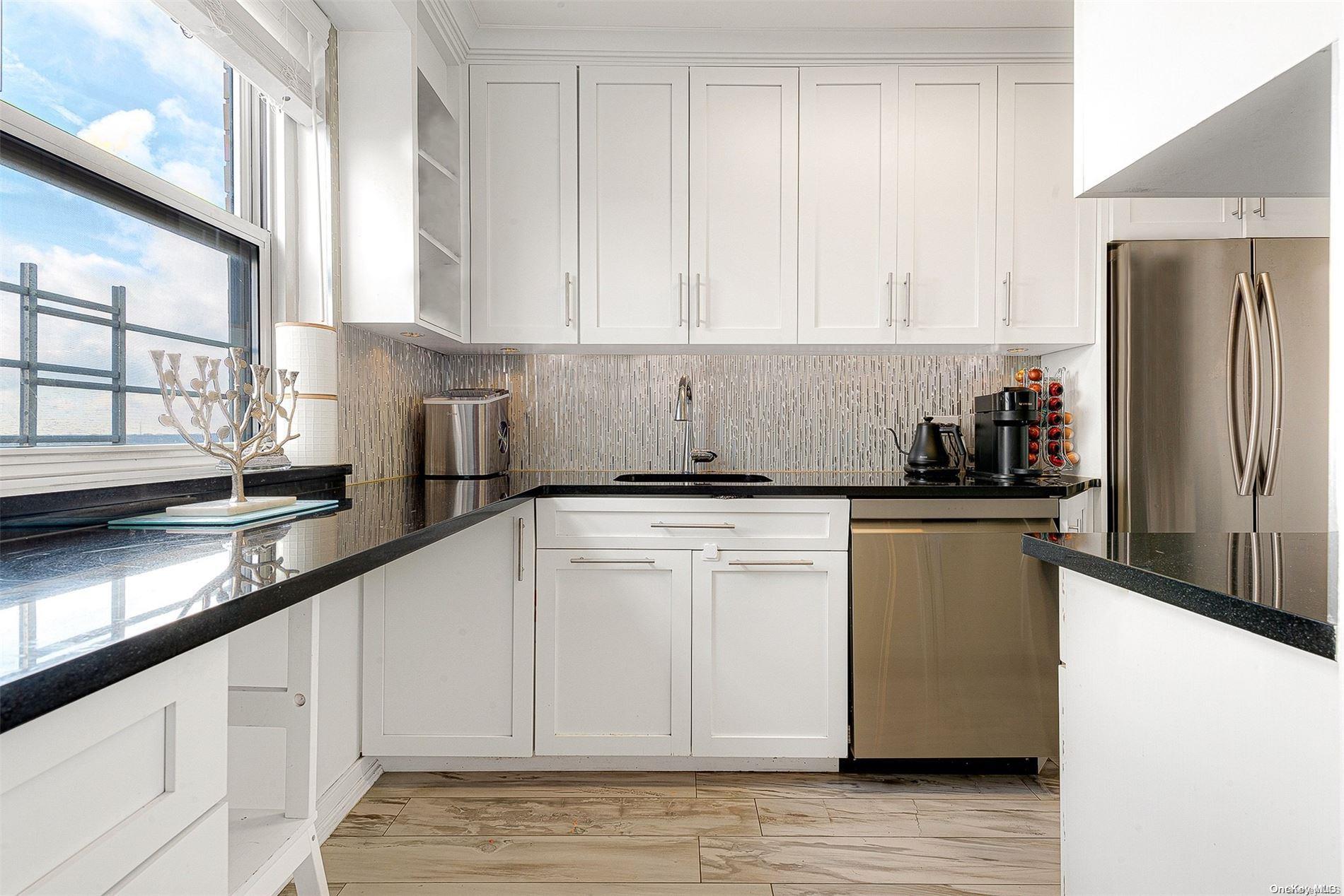 110-11 Queens Boulevard, Unit 20K Queens, NY 11375 - Photo 17 of 35 a kitchen with stainless steel appliances granite countertop a refrigerator a sink a stove and white cabinets