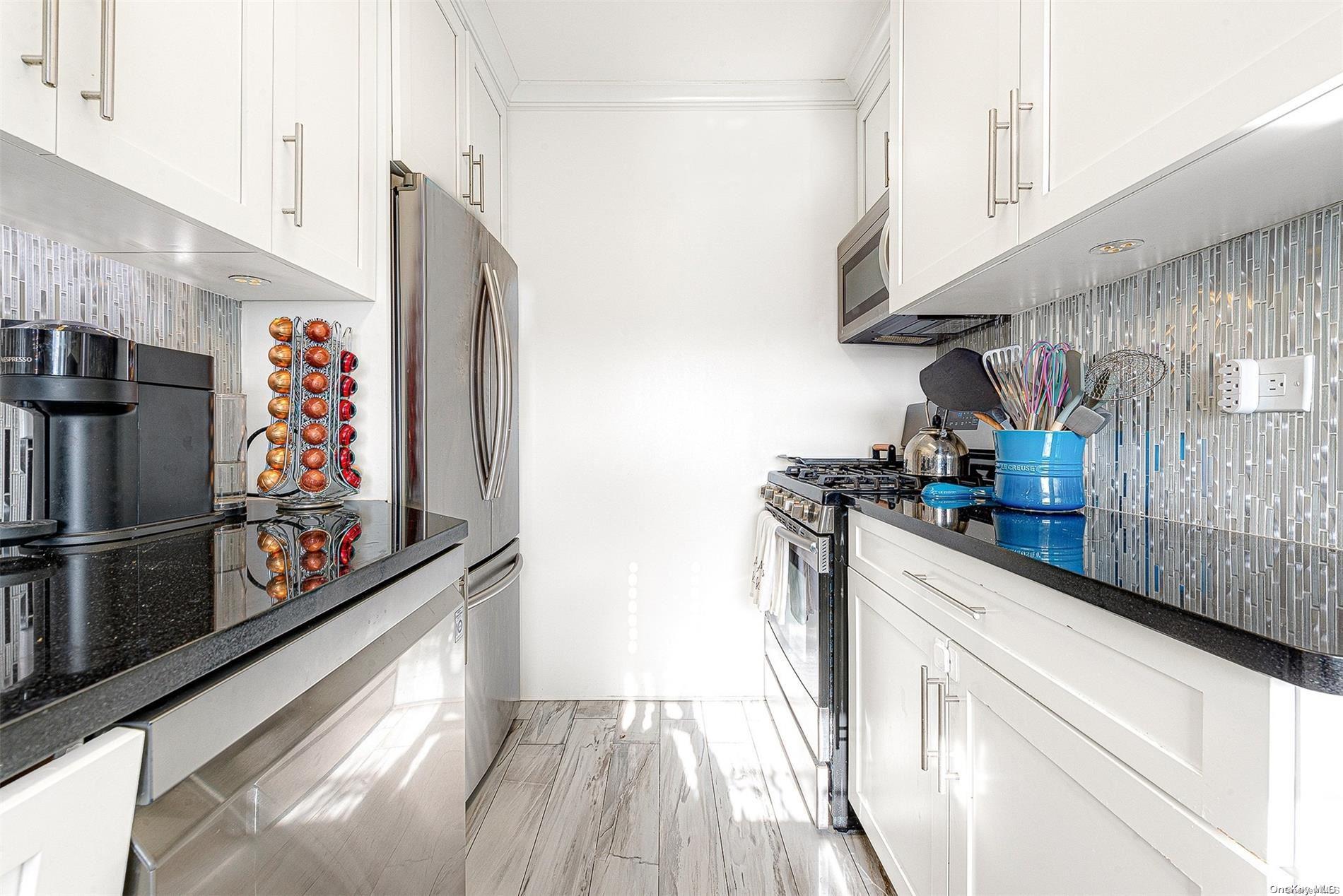 110-11 Queens Boulevard, Unit 20K Queens, NY 11375 - Photo 19 of 35 a kitchen with stainless steel appliances granite countertop a refrigerator and a stove