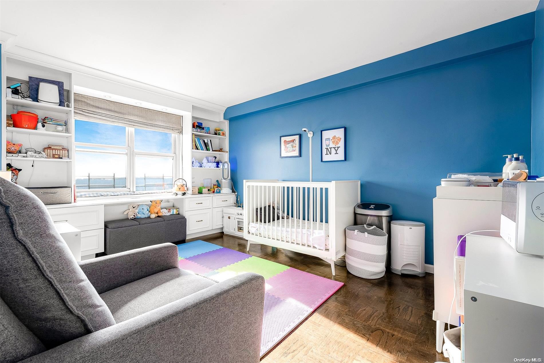 110-11 Queens Boulevard, Unit 20K Queens, NY 11375 - Photo 21 of 35 a living room with furniture and a baby crib