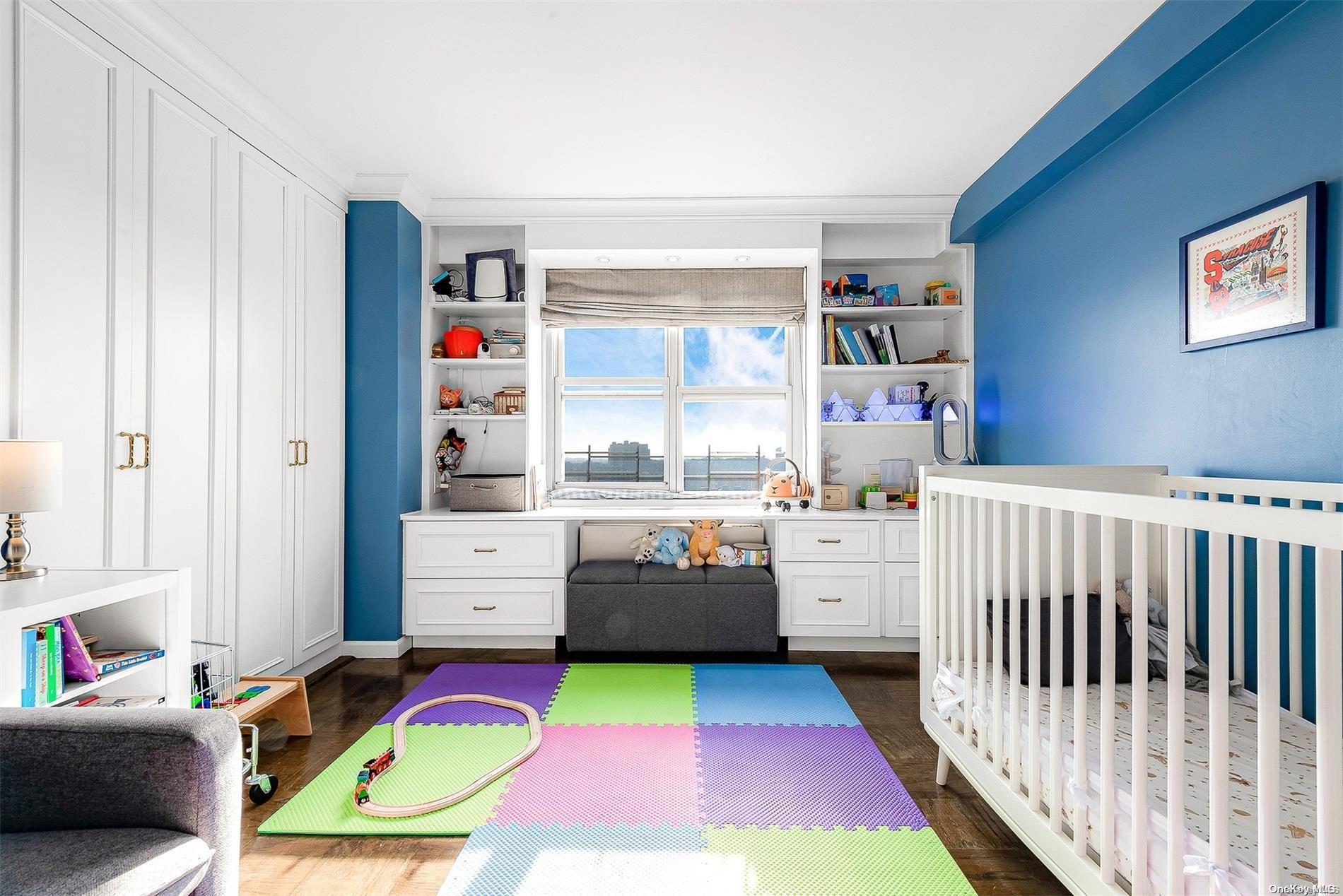 110-11 Queens Boulevard, Unit 20K Queens, NY 11375 - Photo 22 of 35 a bedroom with furniture and a baby crib