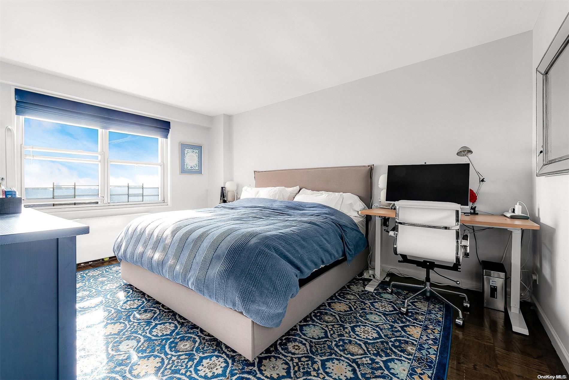 110-11 Queens Boulevard, Unit 20K Queens, NY 11375 - Photo 25 of 35 a bedroom with a bed and chair