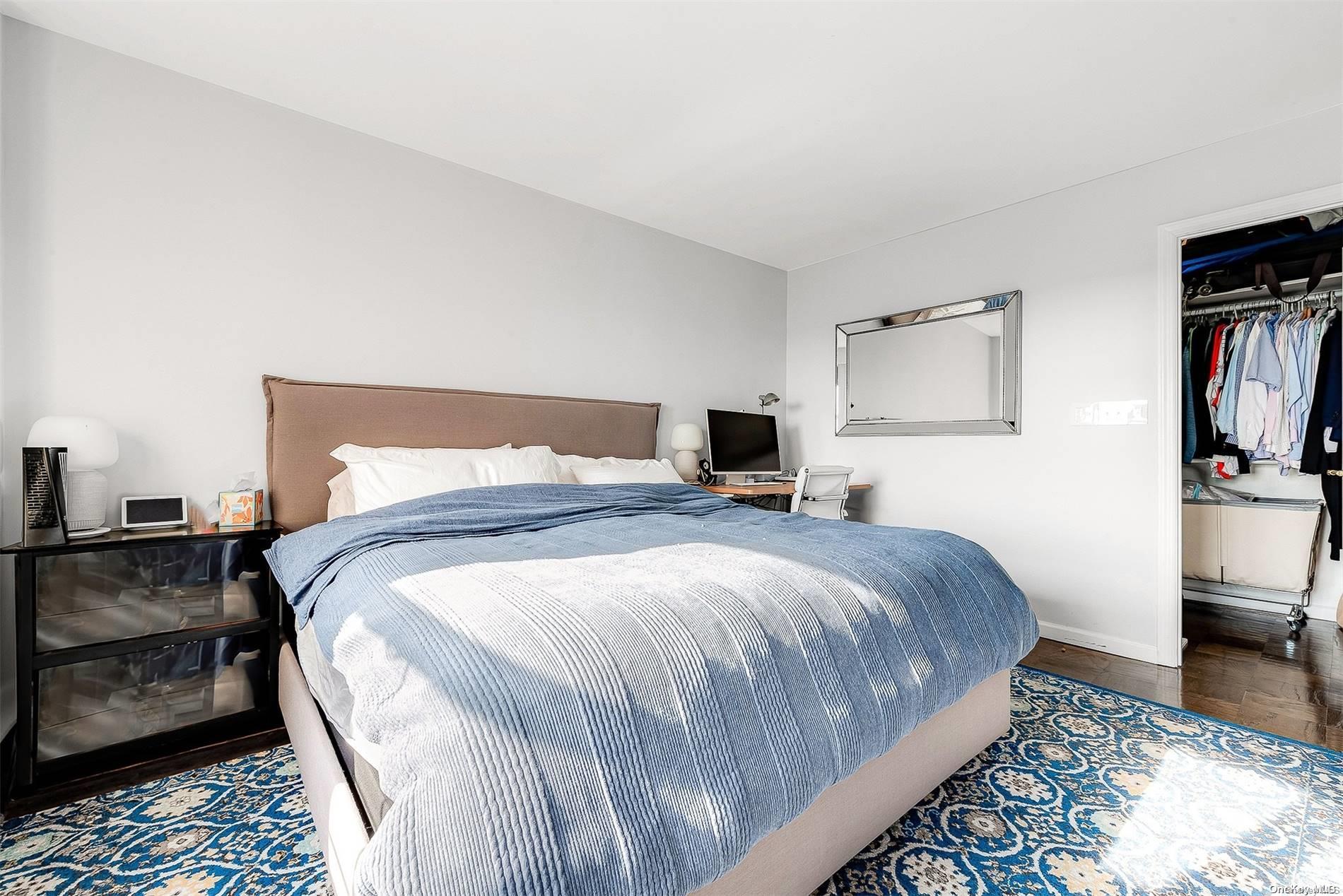 110-11 Queens Boulevard, Unit 20K Queens, NY 11375 - Photo 26 of 35 a bedroom with a bed a tv and wooden floor