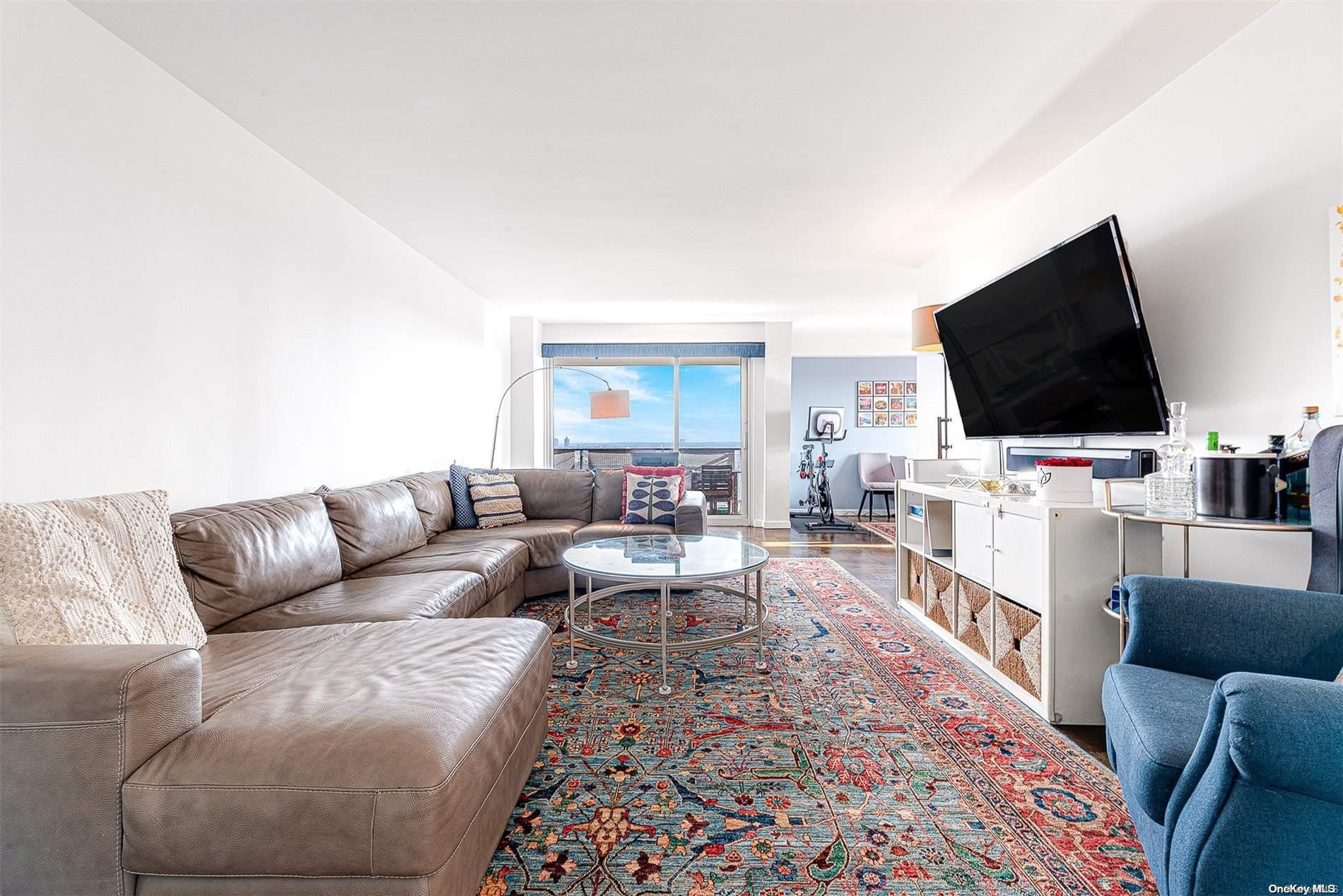 110-11 Queens Boulevard, Unit 20K Queens, NY 11375 - Photo 8 of 35 a living room with furniture and a flat screen tv