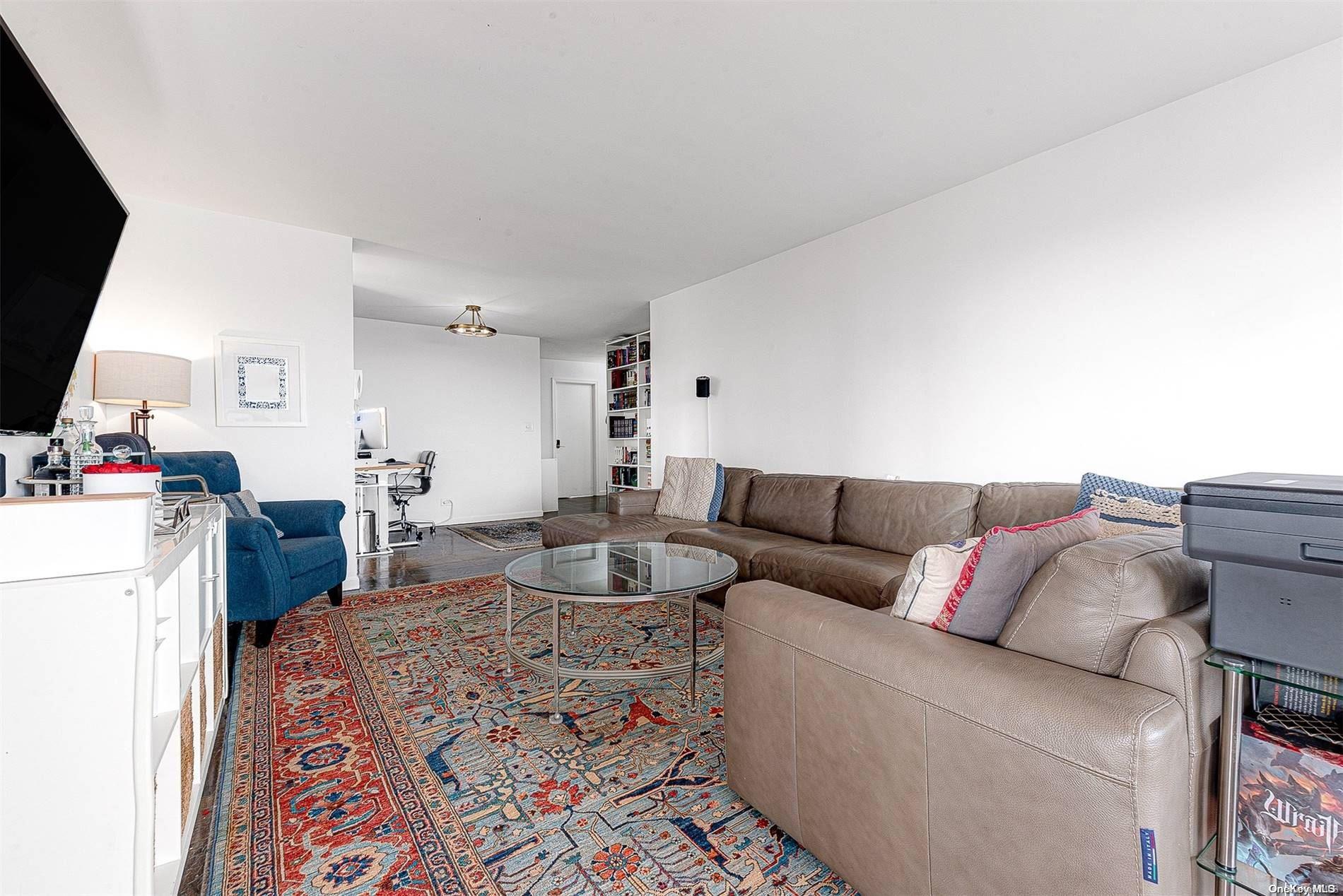 110-11 Queens Boulevard, Unit 20K Queens, NY 11375 - Photo 9 of 35 a living room with furniture and a flat screen tv