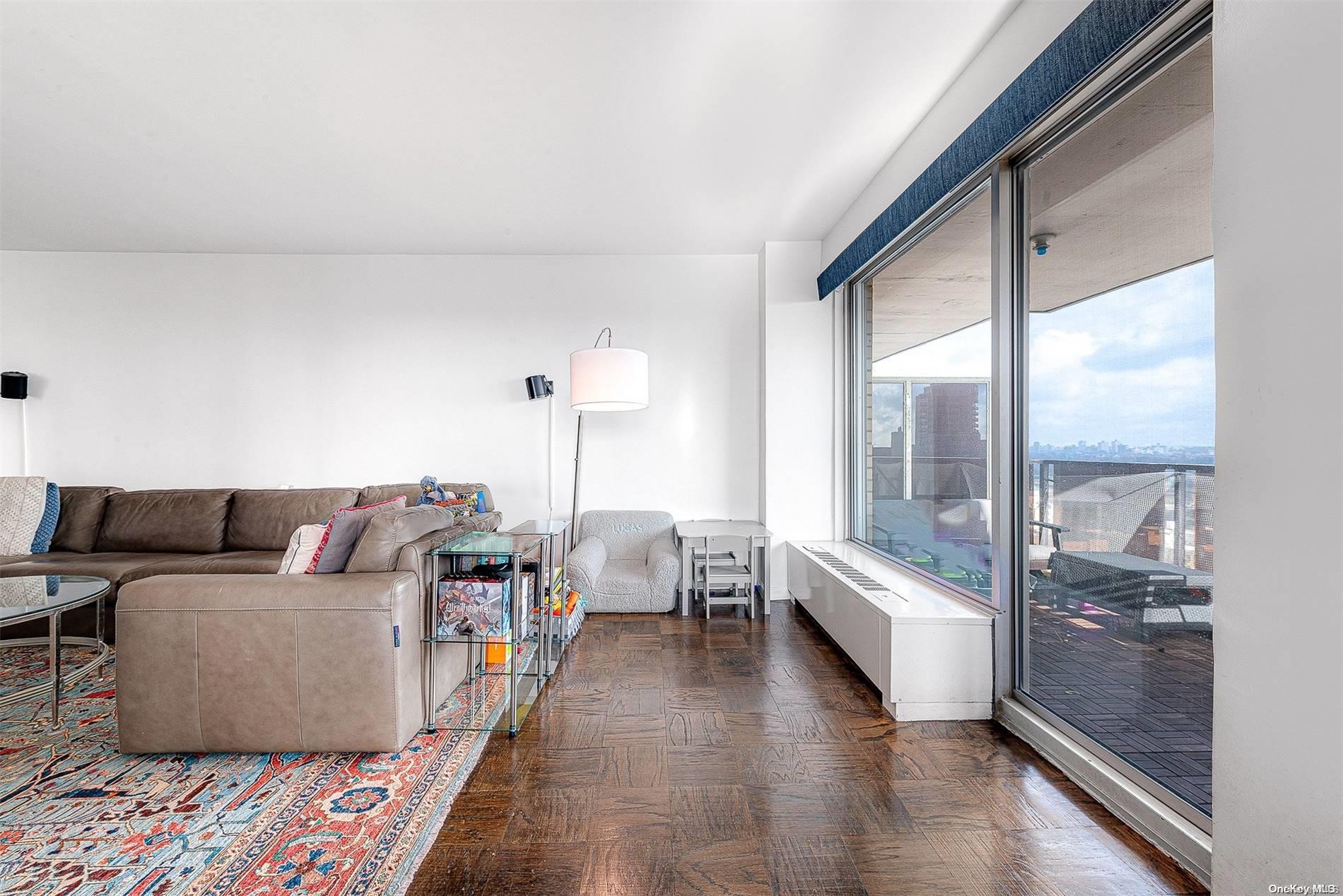 110-11 Queens Boulevard, Unit 20K Queens, NY 11375 - Photo 10 of 35 a living room with furniture and a large window