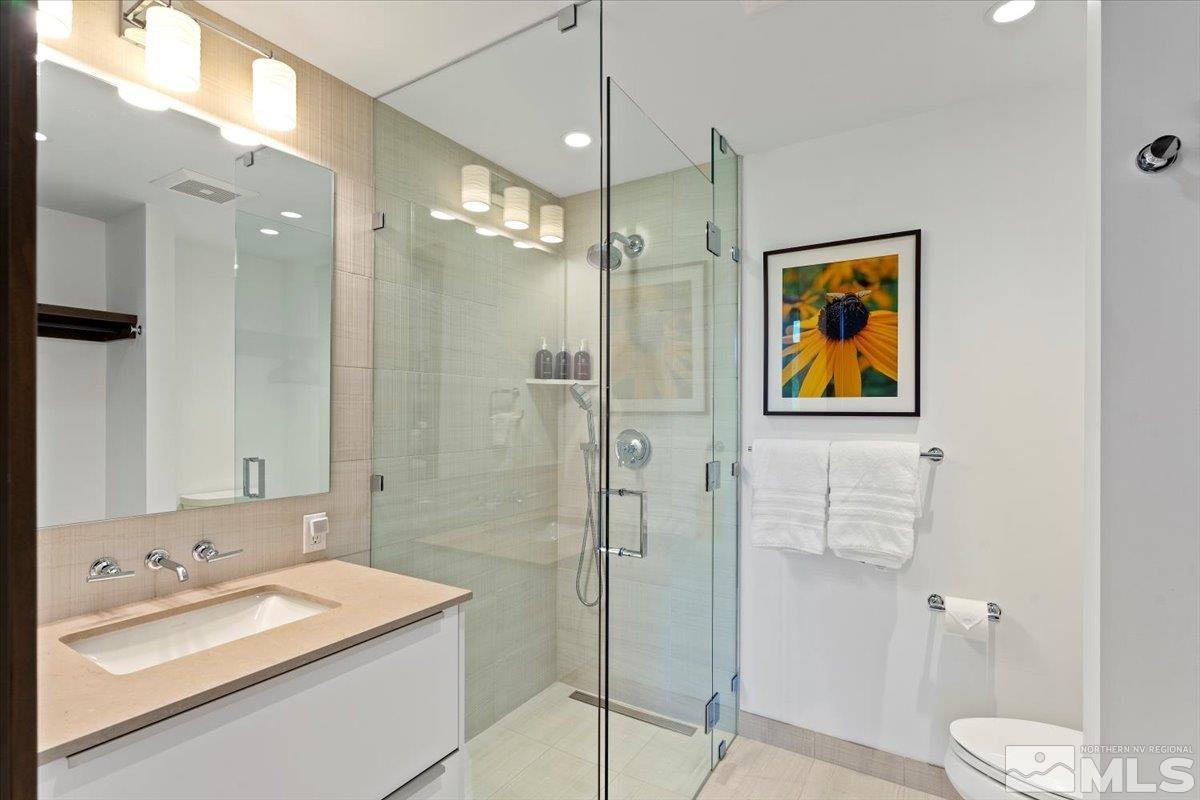 9 Beach Club Drive, Unit 111 Stateline, NV 89449 - Photo 17 of 40 a bathroom with a sink a toilet and shower