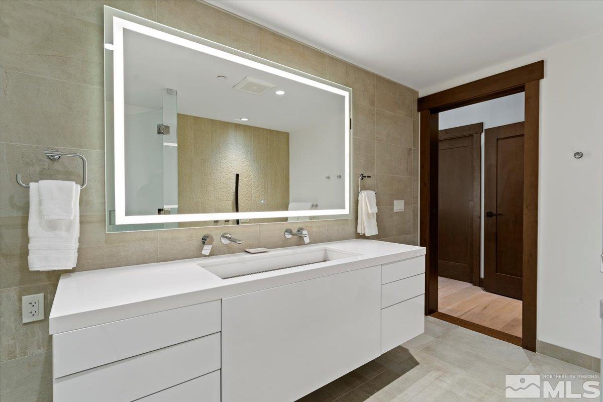 9 Beach Club Drive, Unit 111 Stateline, NV 89449 - Photo 20 of 40 a bathroom with a double vanity sink and mirror