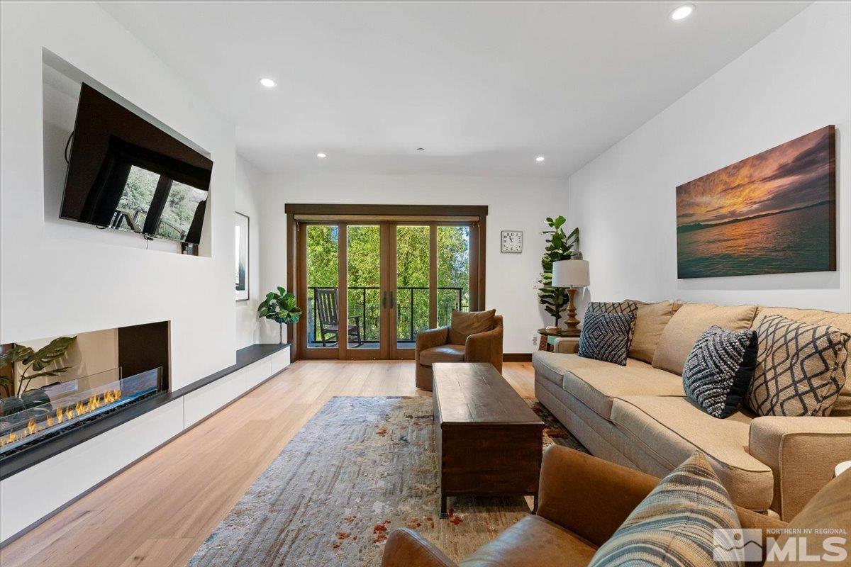 9 Beach Club Drive, Unit 111 Stateline, NV 89449 - Photo 2 of 40 a living room with furniture fireplace and flat screen tv