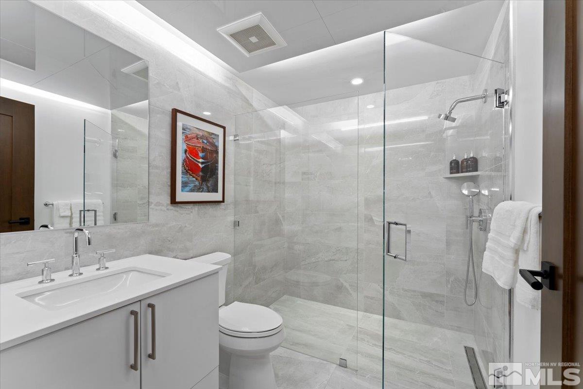 9 Beach Club Drive, Unit 111 Stateline, NV 89449 - Photo 23 of 40 a bathroom with a sink toilet and shower
