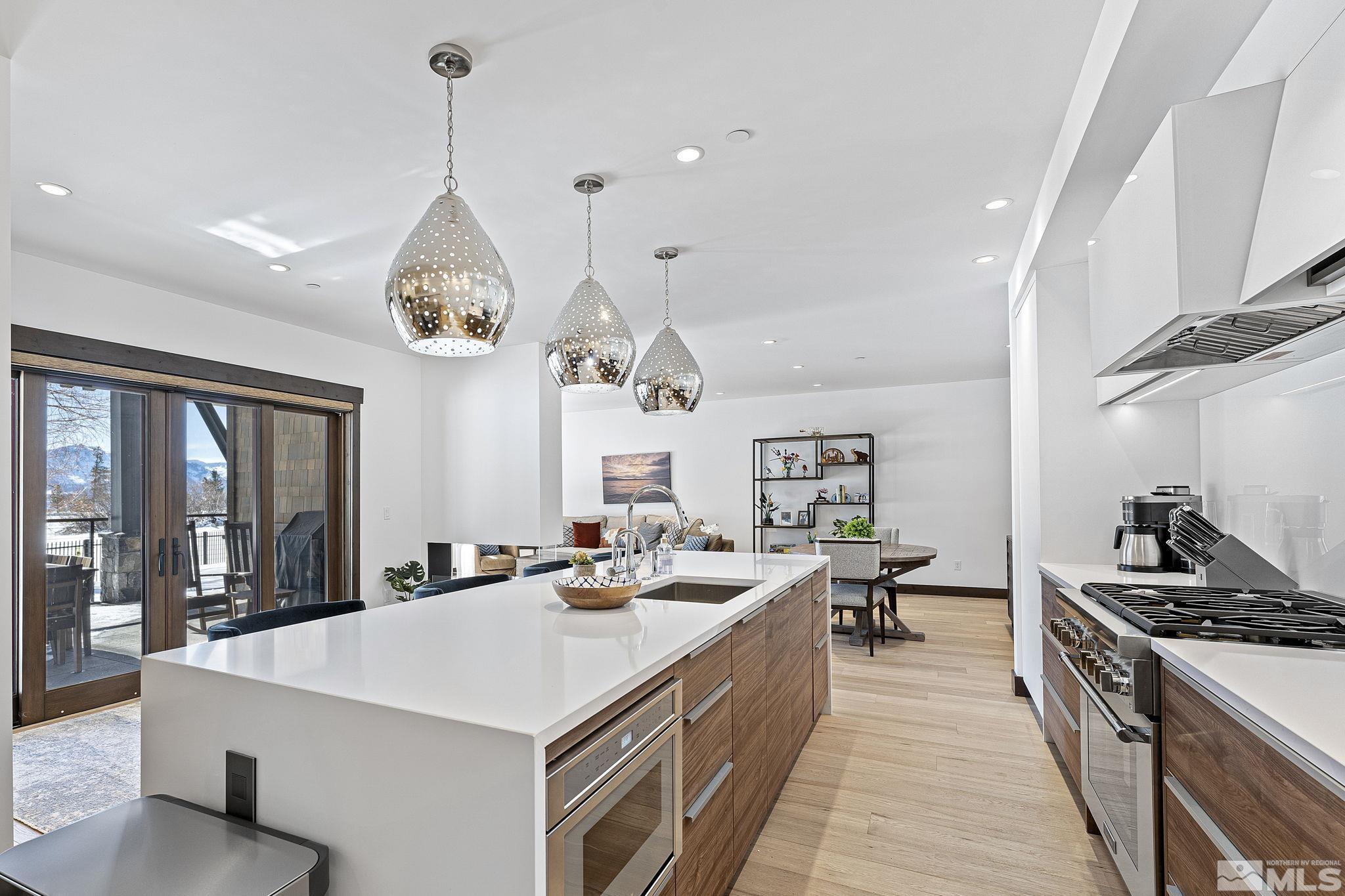 9 Beach Club Drive, Unit 111 Stateline, NV 89449 - Photo 9 of 40 a large kitchen with sink a stove and chairs