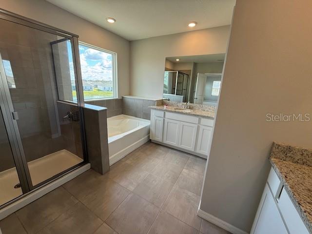 5644 Flagstone Trail Palmetto, FL 34221 - Photo 15 of 25 a bathroom with a double vanity sink toilet and tub