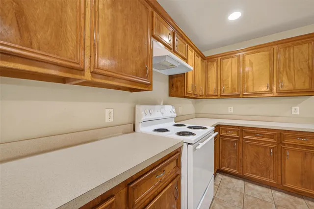 a view of a kitchen with sink and cabinets