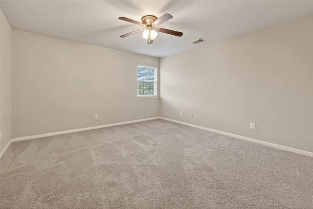 a view of a room with a ceiling fan and a chandelier fan
