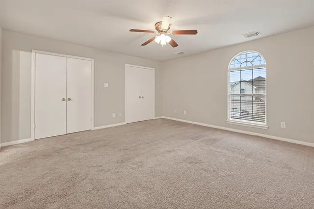 a view of a room with a ceiling fan