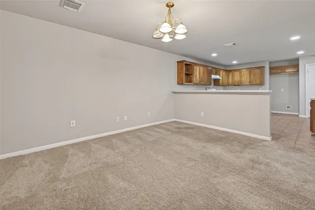 a view of a livingroom with a chandelier fan