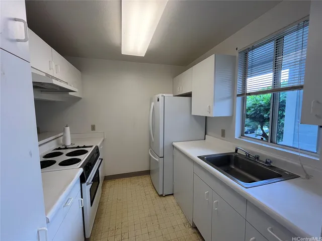 a kitchen that has a sink and a stove