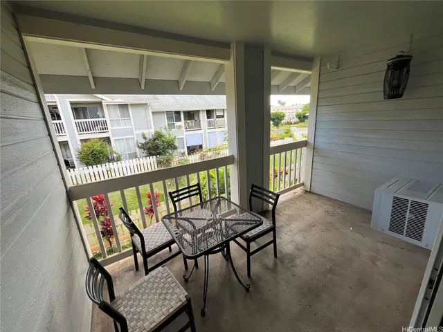 a view of a chairs and table in the balcony