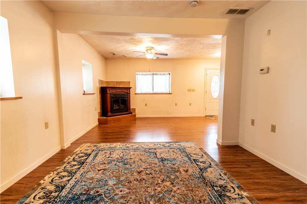 210 Whitestown Road Butler, PA 16001 - Photo 5 of 21 a view of empty room with wooden floor and fireplace
