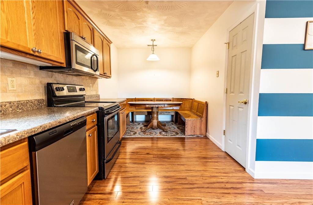 210 Whitestown Road Butler, PA 16001 - Photo 8 of 21 a view of a kitchen with stainless steel appliances granite countertop a stove and a wooden floor