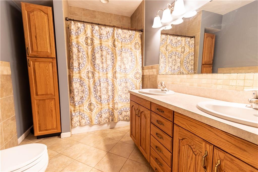 210 Whitestown Road Butler, PA 16001 - Photo 9 of 21 a spacious bathroom with a granite countertop sink and a bathtub