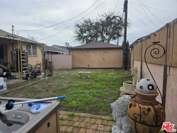 a view of a backyard with wooden fence