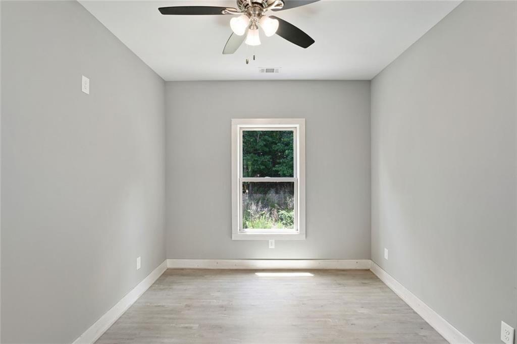 2040 Ridge Road Cumming, GA 30041 - Photo 30 of 52 an empty room with a window and a ceiling fan
