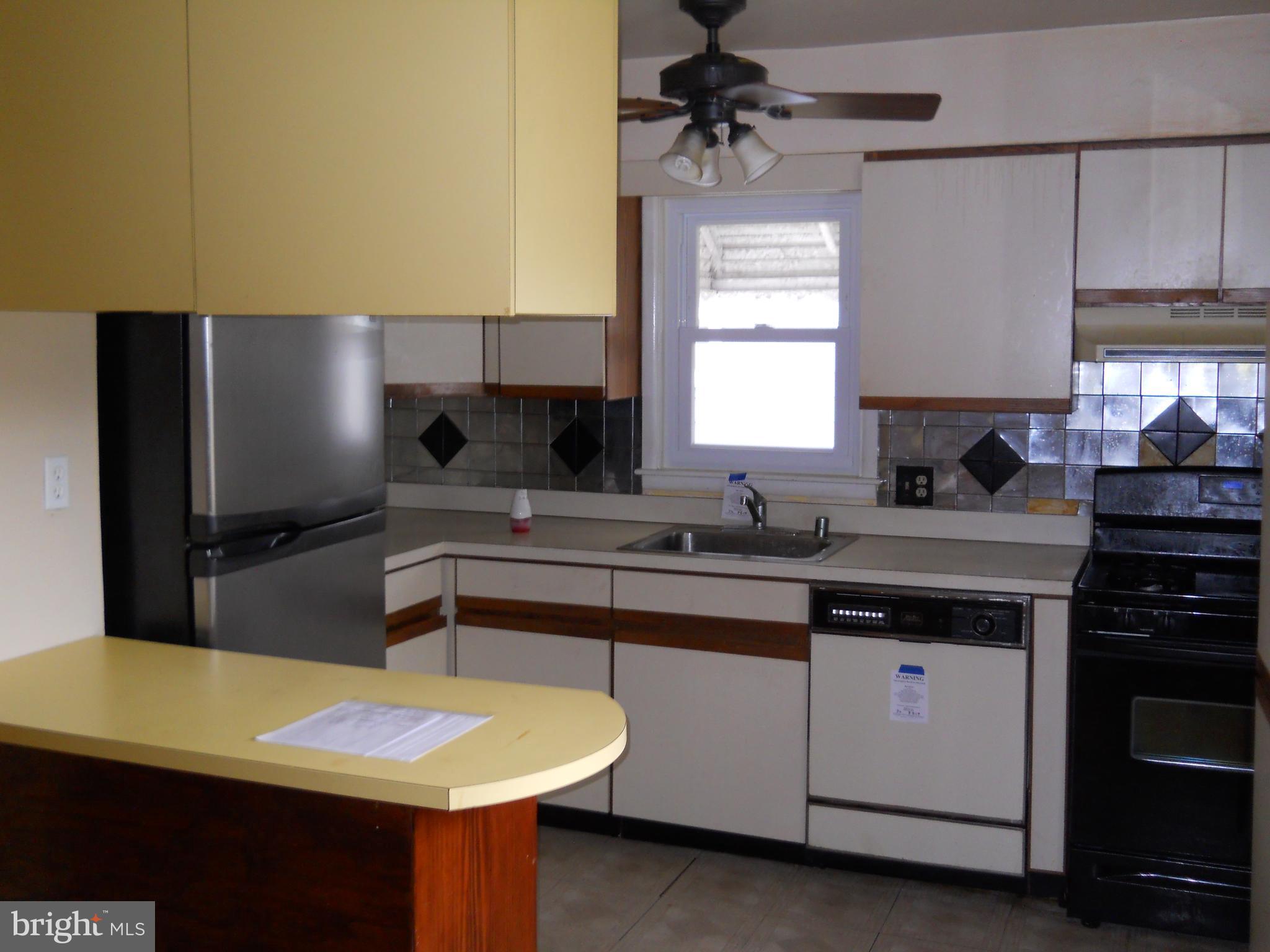 7415 Remoor Road Baltimore, MD 21207 - Photo 11 of 45 a kitchen with a sink cabinets and window