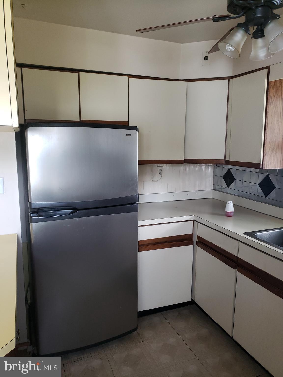 7415 Remoor Road Baltimore, MD 21207 - Photo 13 of 45 a kitchen with metallic refrigerator and sink