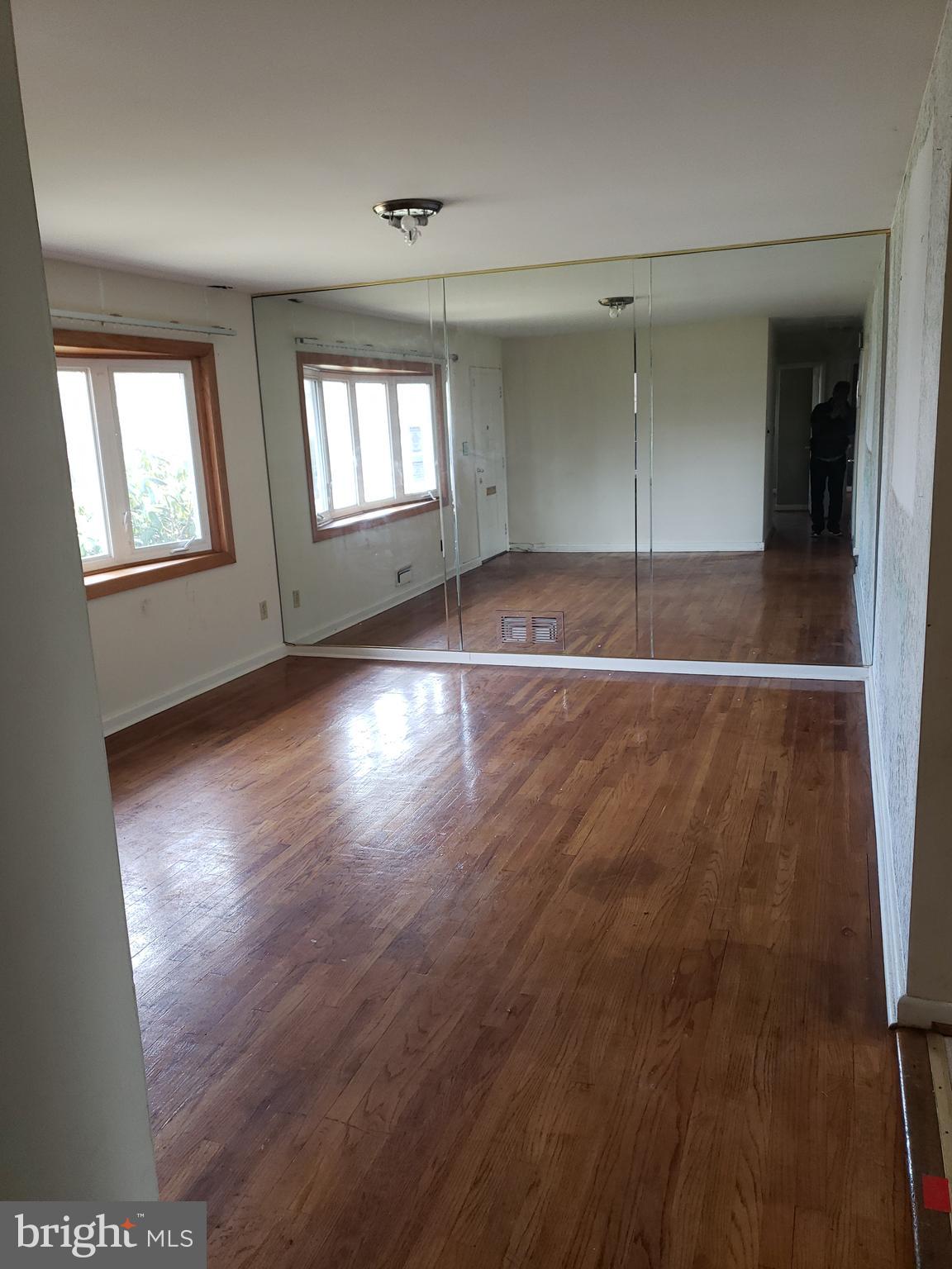 7415 Remoor Road Baltimore, MD 21207 - Photo 17 of 45 an empty room with wooden floor and windows