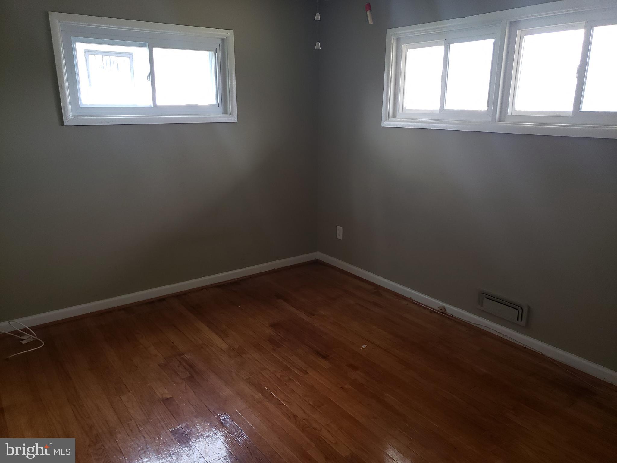 7415 Remoor Road Baltimore, MD 21207 - Photo 21 of 45 an empty room with wooden floor and windows