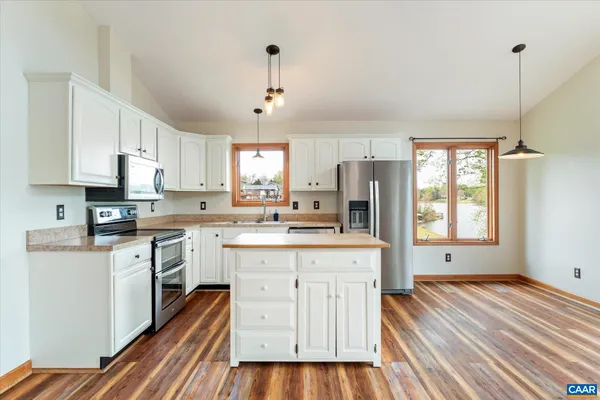 a view of a house with a wooden fence