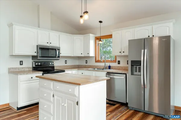 a view of a house with a yard covered in snow