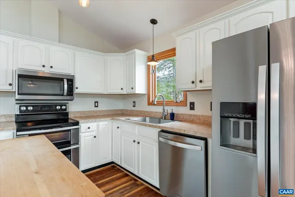 a view of a balcony with wooden floor and fence and a stove
