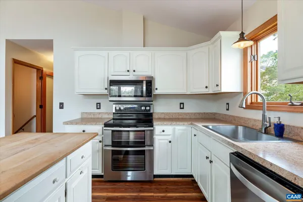 a backyard of a house with lots of green space and lake view