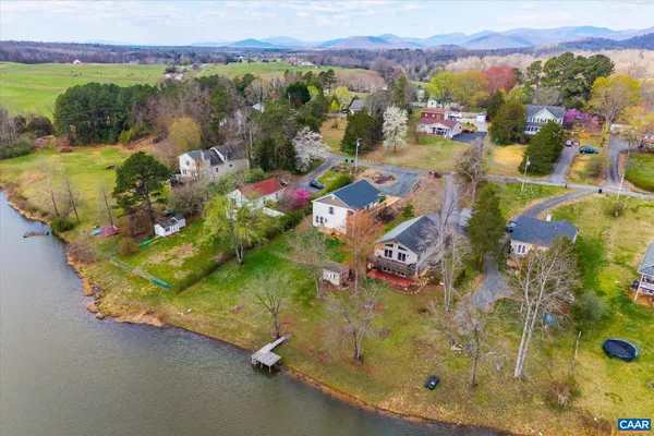 a large kitchen with stainless steel appliances granite countertop a stove a sink dishwasher and a refrigerator with wooden floor