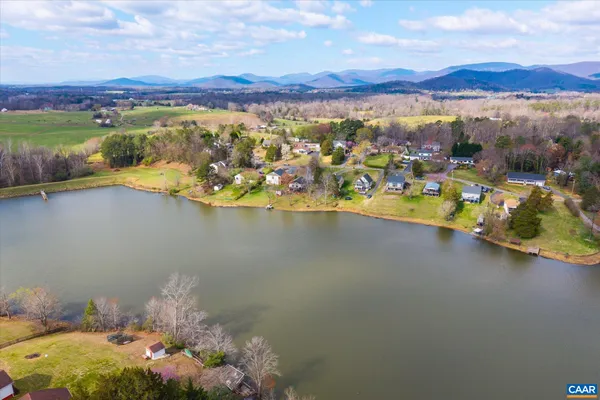a bathroom with a sink mirror and a toilet
