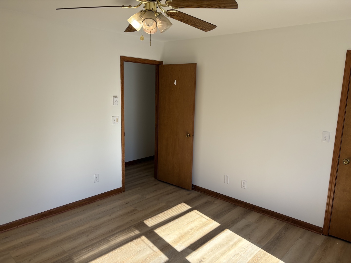 322 West Railroad Street, Unit 3 Marengo, IL 60152 - Photo 18 of 26 an empty room with wooden floor and chandelier fan