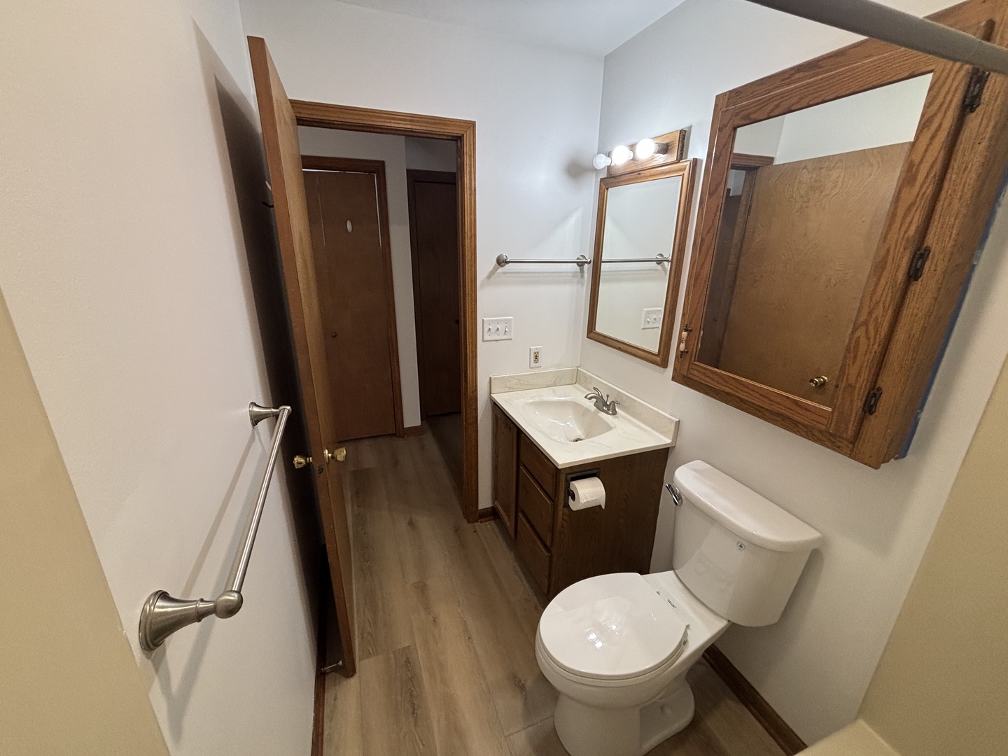 322 West Railroad Street, Unit 3 Marengo, IL 60152 - Photo 21 of 26 a bathroom with a sink a toilet a mirror and vanity