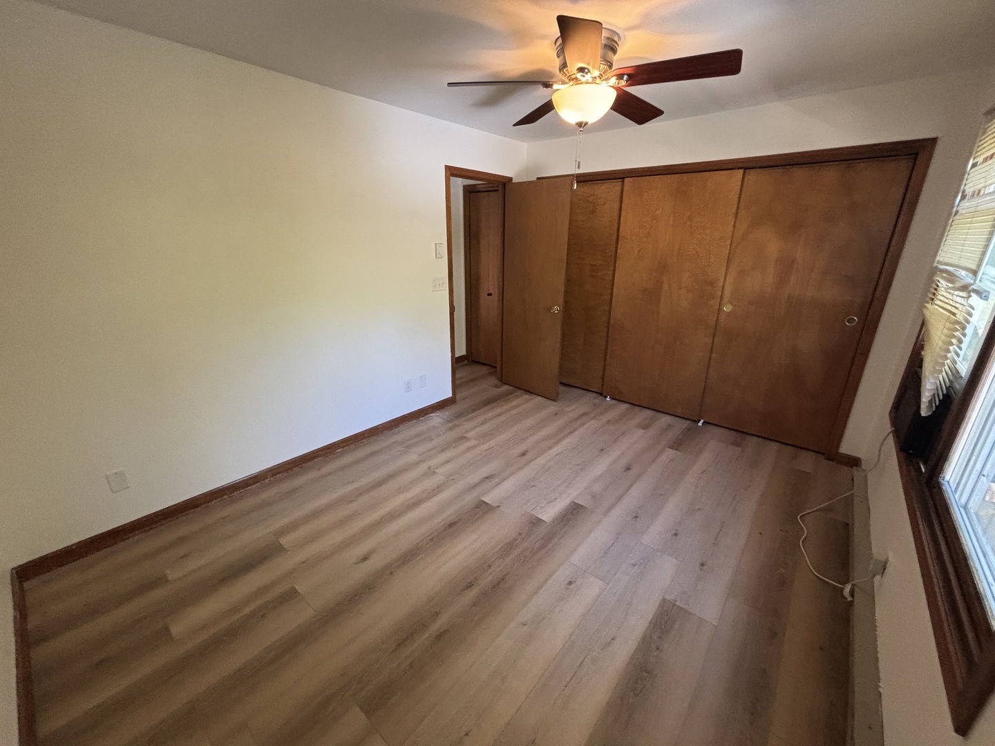 322 West Railroad Street, Unit 3 Marengo, IL 60152 - Photo 23 of 26 wooden floor in an empty room with a window