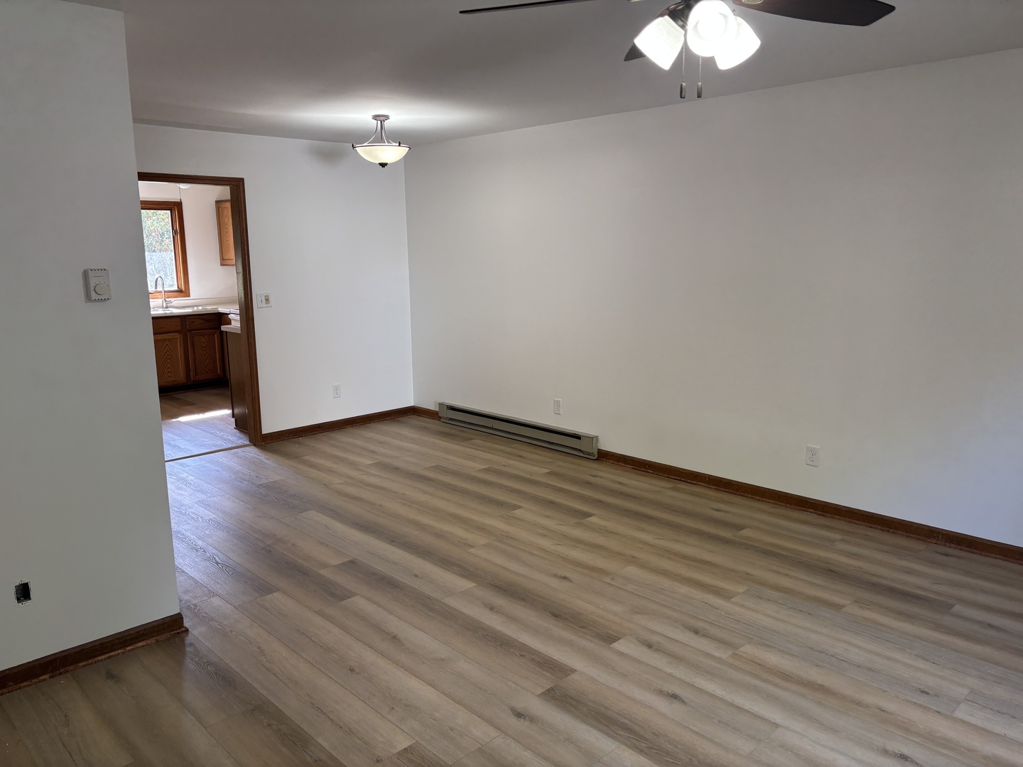 322 West Railroad Street, Unit 3 Marengo, IL 60152 - Photo 5 of 26 a view of a room with wooden floor and white walls