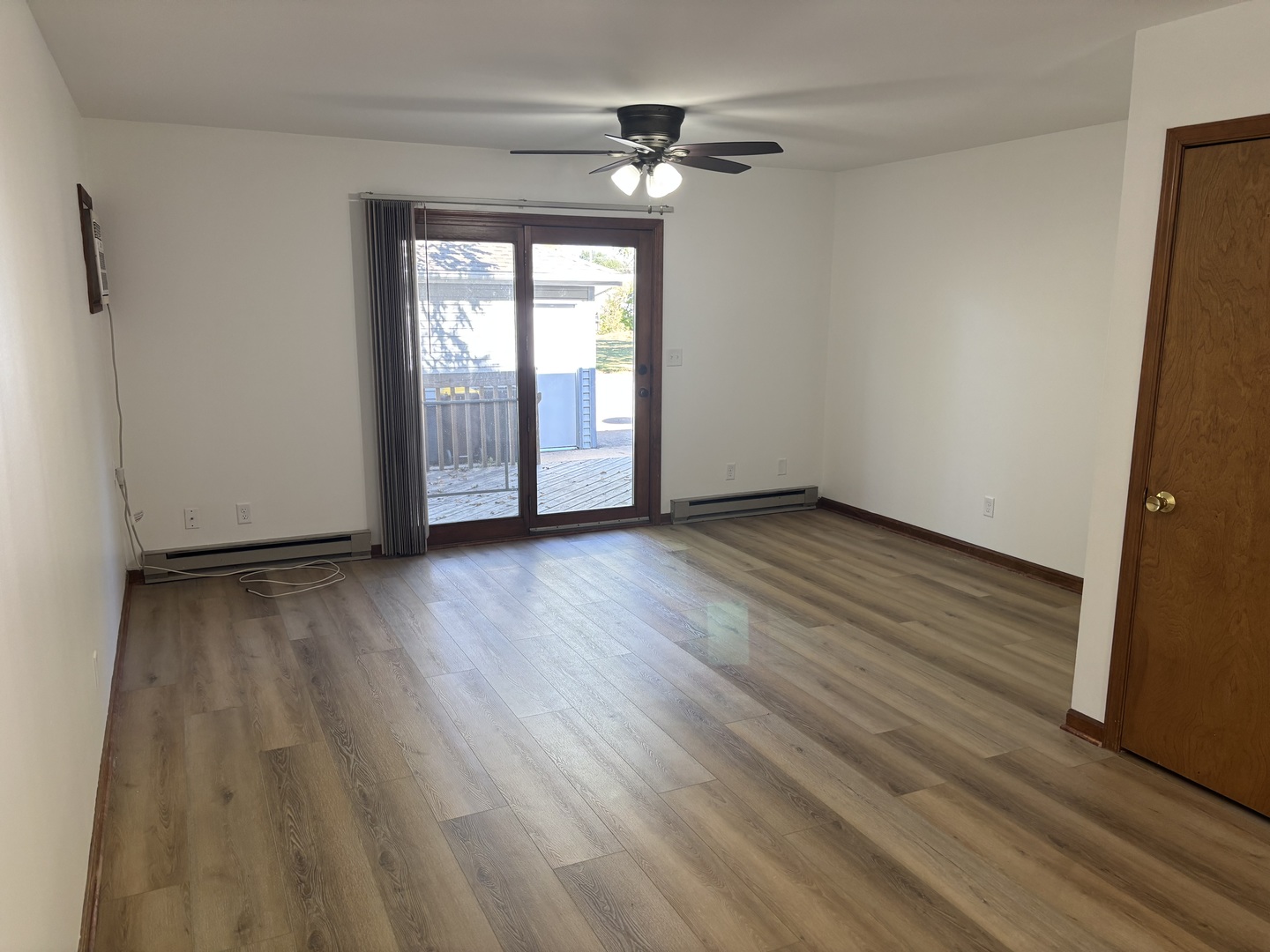 322 West Railroad Street, Unit 3 Marengo, IL 60152 - Photo 8 of 26 a view of an empty room with wooden floor and a window