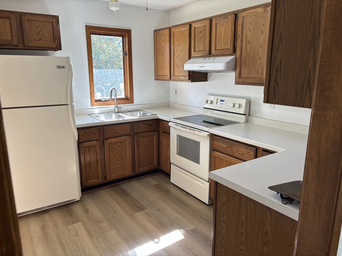 322 West Railroad Street, Unit 3 Marengo, IL 60152 - Photo 10 of 26 a kitchen with stainless steel appliances granite countertop a stove a refrigerator and a sink with wooden floors