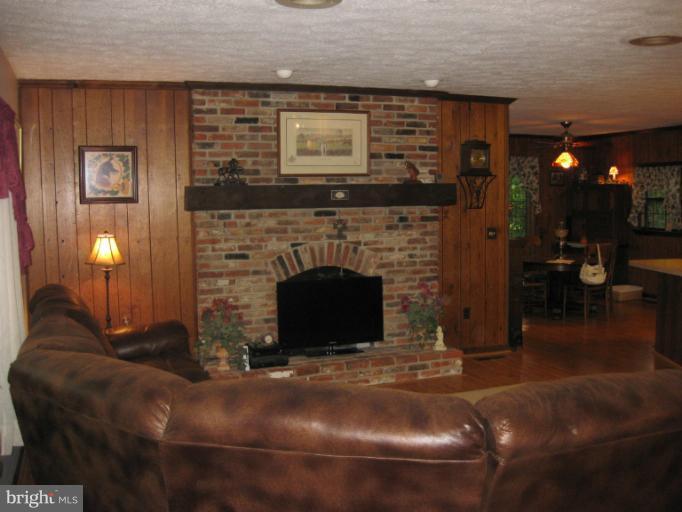 1980 Plum Point Road Huntingtown, MD 20639 - Photo 16 of 27 a living room with a fireplace