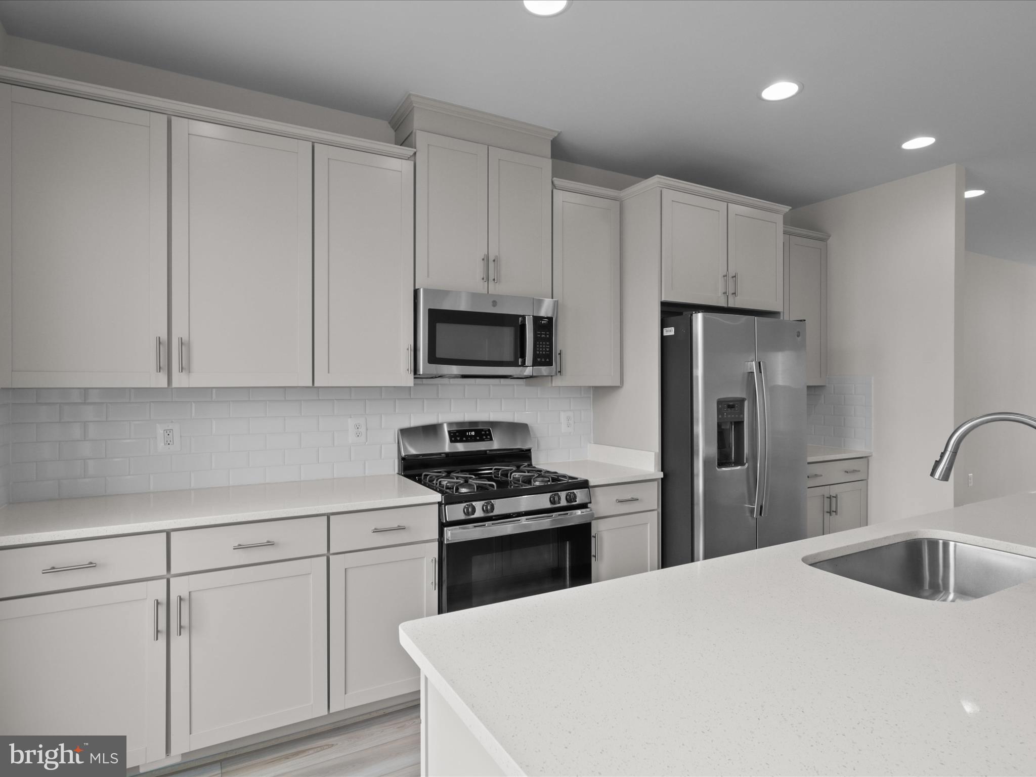 14564 Alsace Lane Gainesville, VA 20155 - Photo 11 of 44 a kitchen with white cabinets and stainless steel appliances