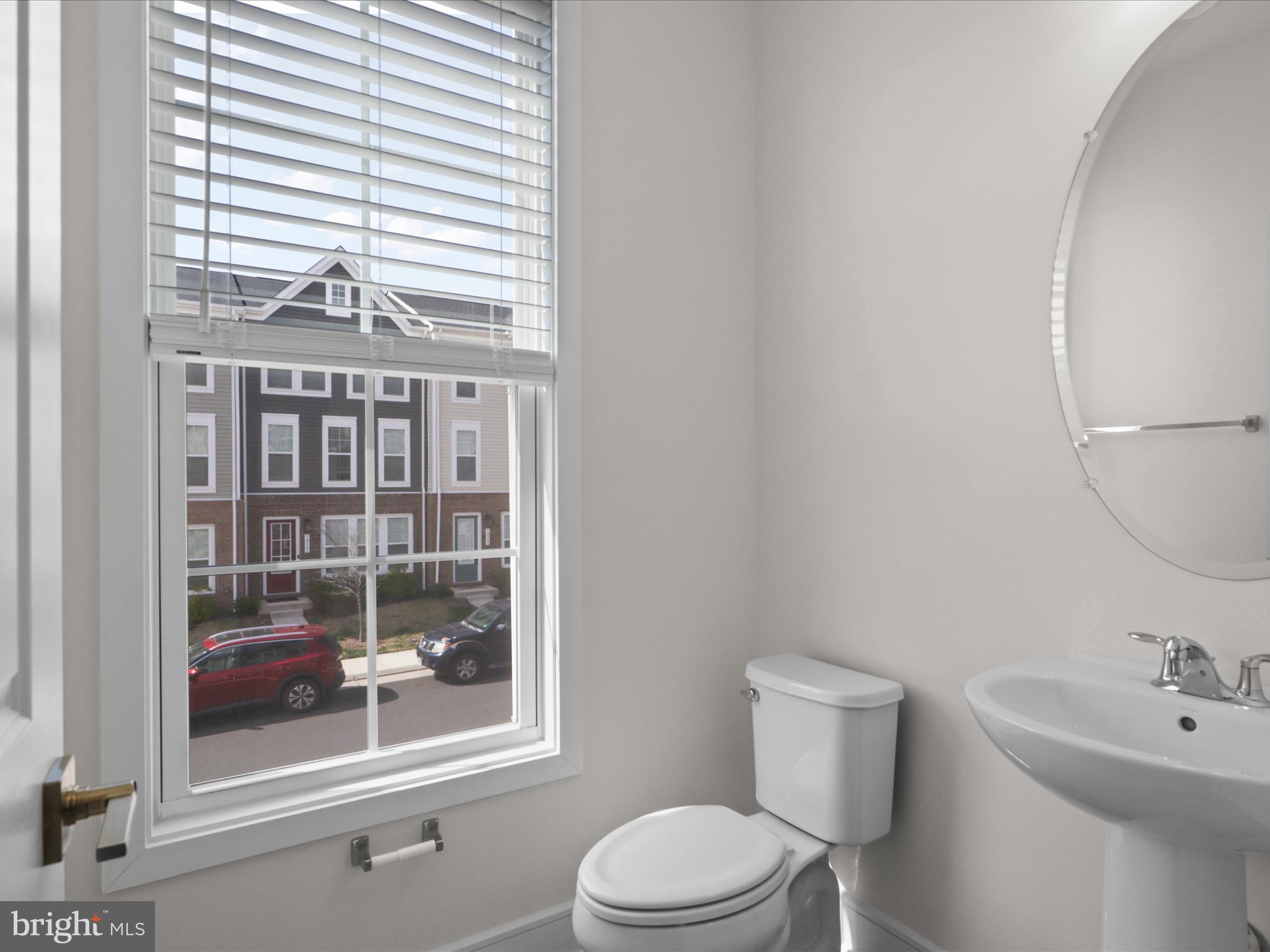 14564 Alsace Lane Gainesville, VA 20155 - Photo 18 of 44 a bathroom with a toilet a sink and a window