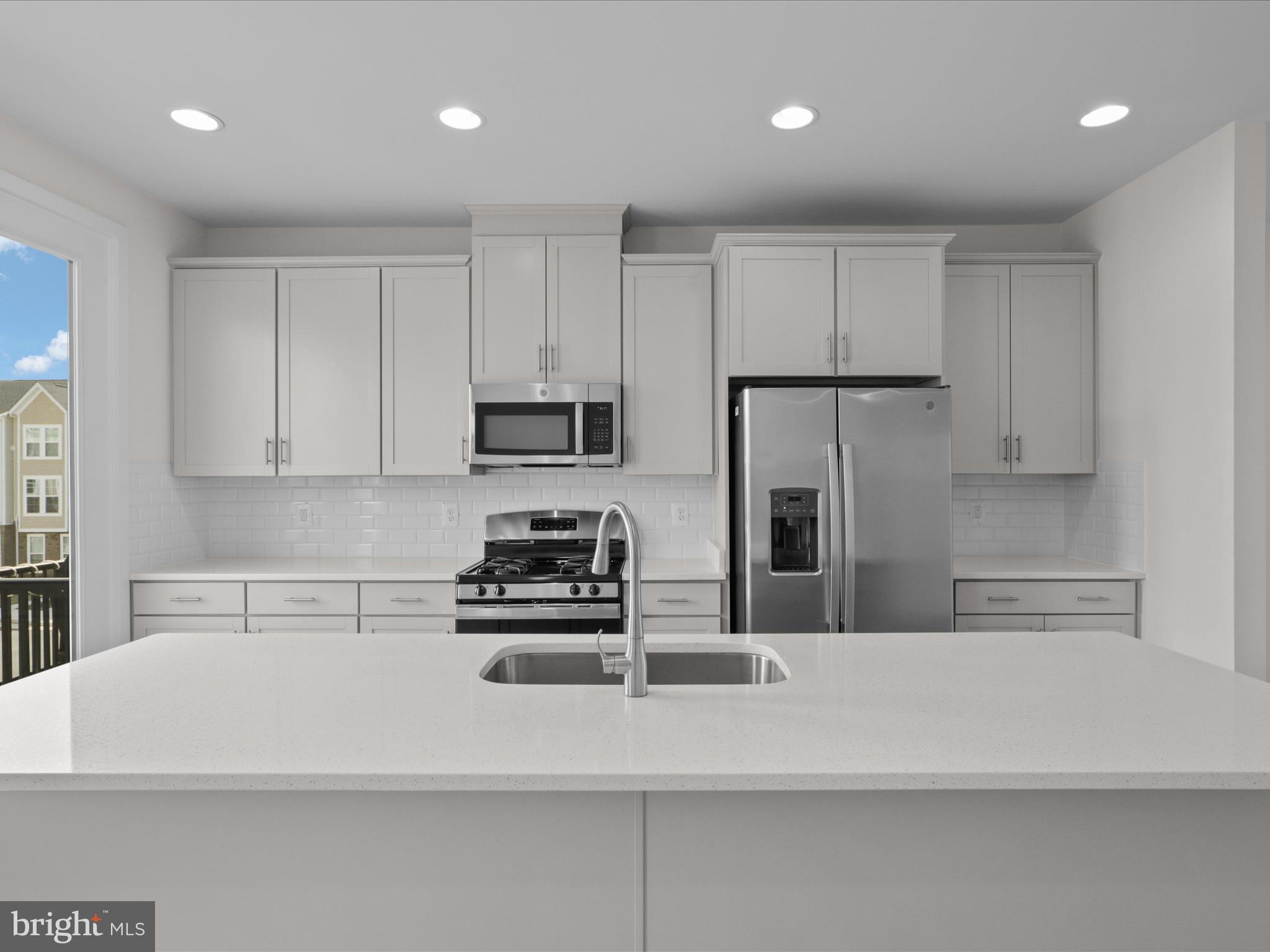 14564 Alsace Lane Gainesville, VA 20155 - Photo 10 of 44 a kitchen with kitchen island a sink stainless steel appliances and cabinets