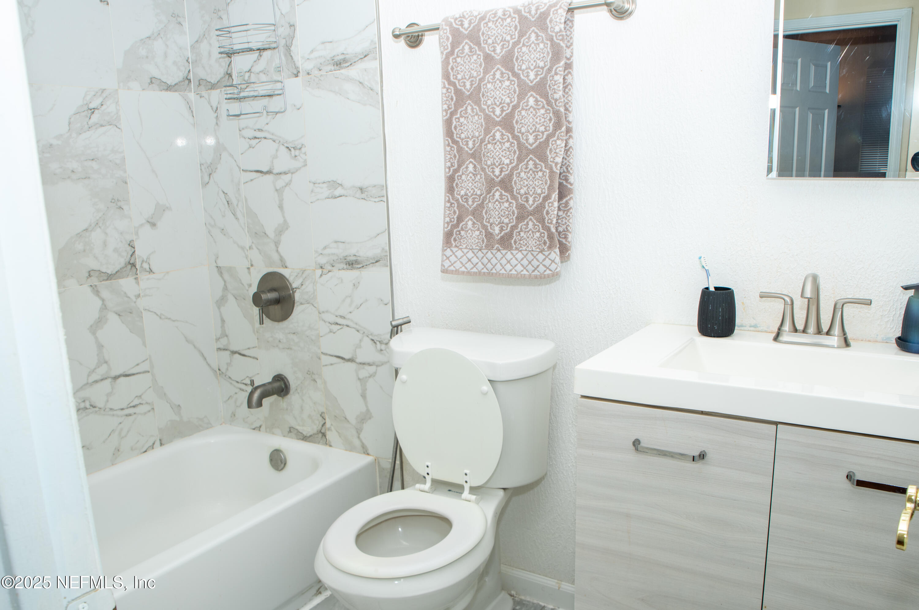 4822 Windrush Lane Jacksonville, FL 32217 - Photo 12 of 13 a bathroom with a sink a toilet and shower