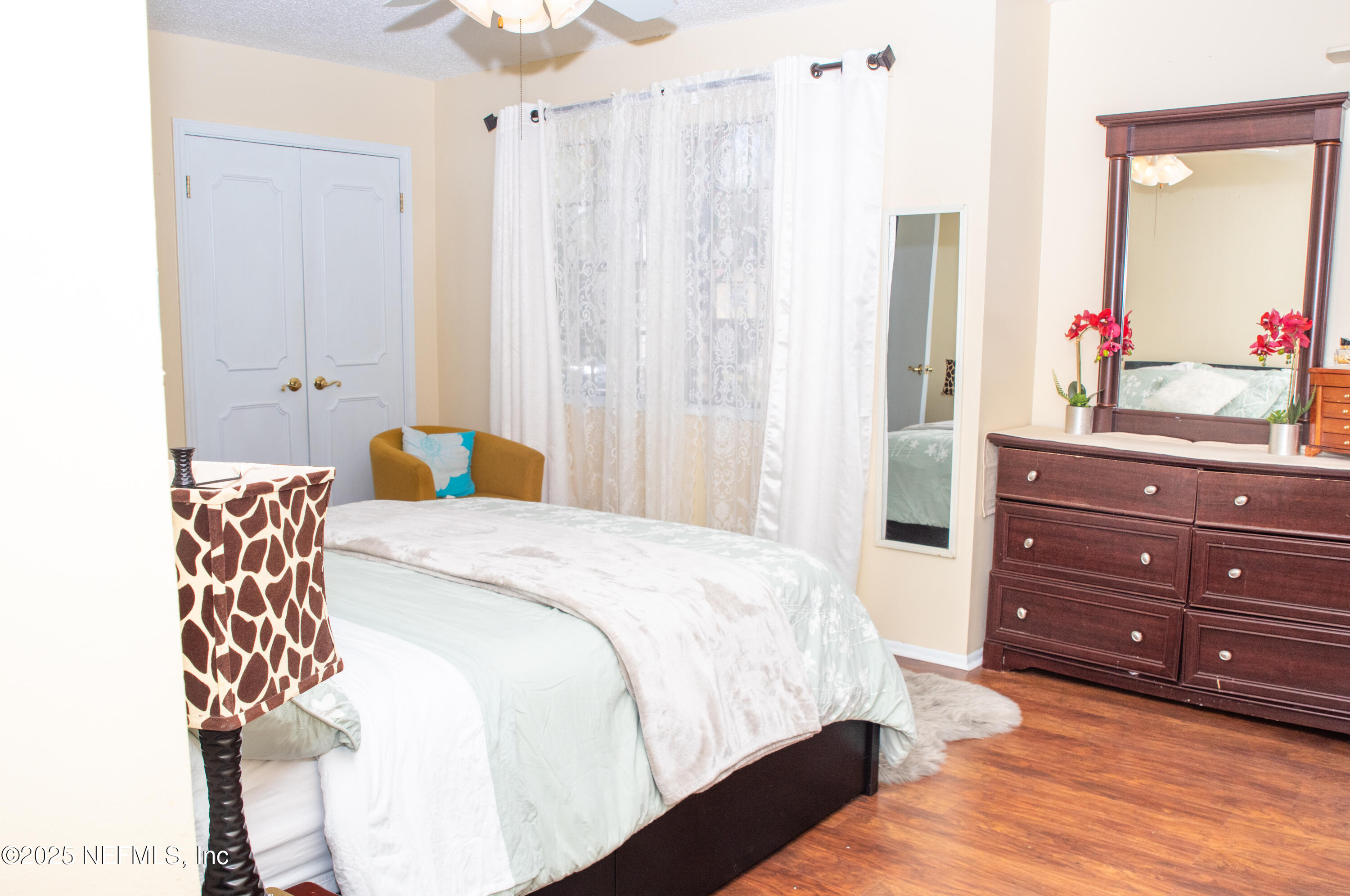 4822 Windrush Lane Jacksonville, FL 32217 - Photo 13 of 13 a bedroom with a bed and a dresser