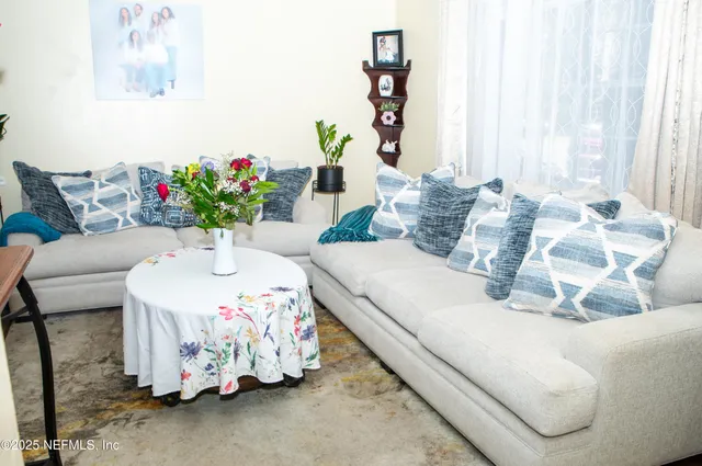 a living room with furniture and flowers
